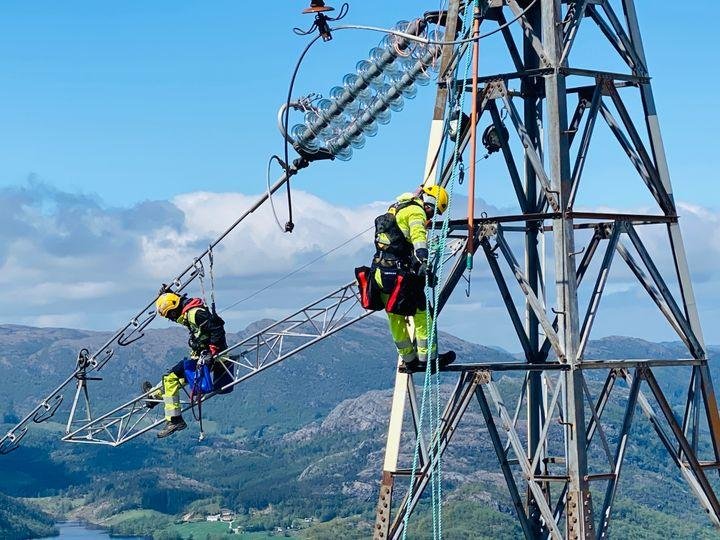 Electrician working on an electricity transmission structure